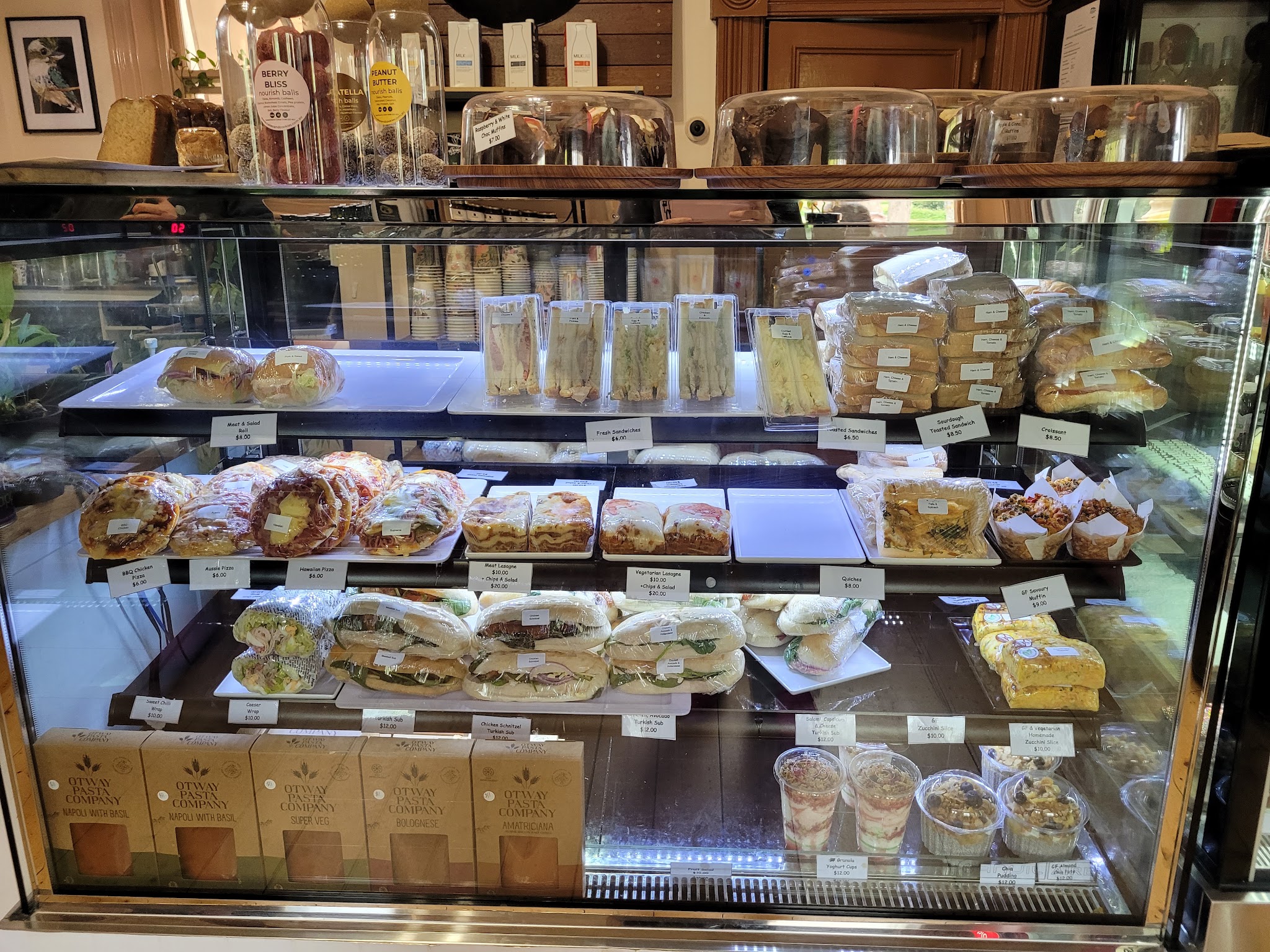 The display cabinet at The Shire Cafe, filled with sandwiches, wraps, Turkish subs, quiche and slices